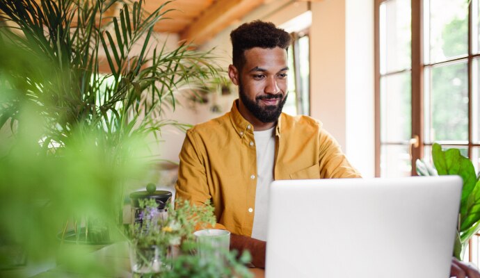 Young man using laptop with headphones
